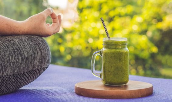 Woman relaxing with a green smoothie