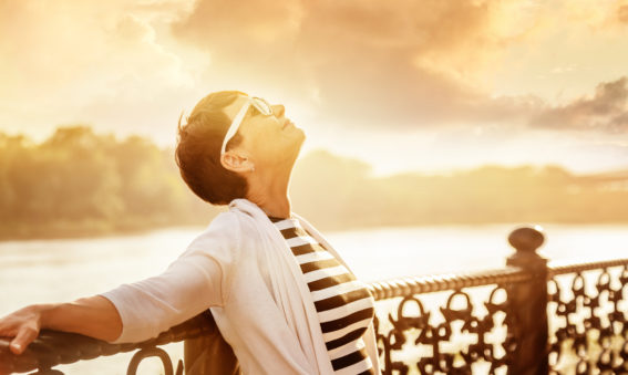 Portrait of a happy attractive mature senior woman 50 years old at sunset